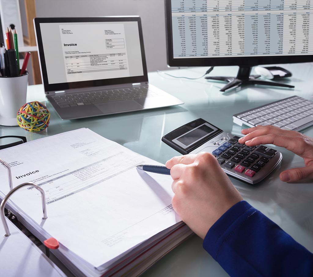 Financial professional reviewing documents and financial reports for Franklin Park Senior Living management services.