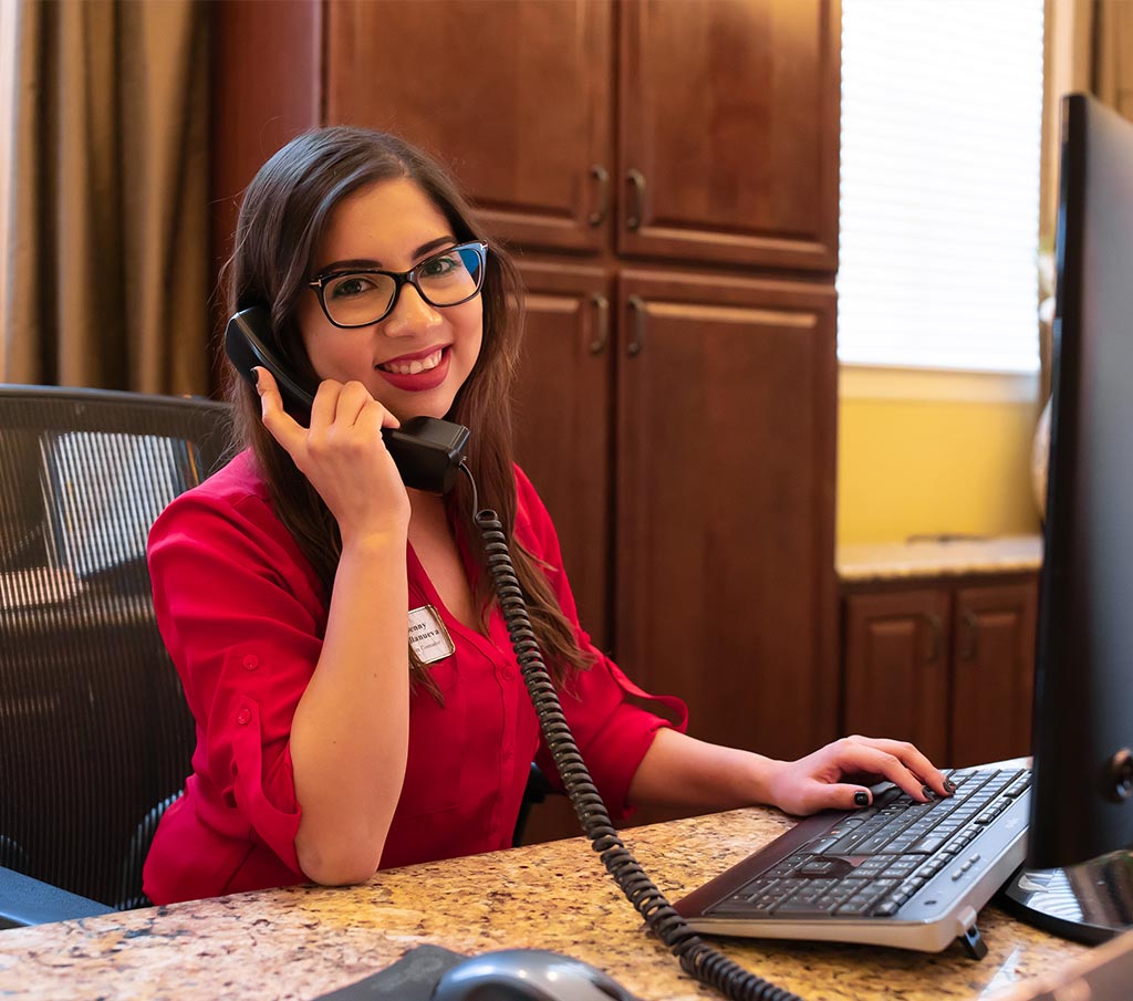 Franklin Park Senior Living professional speaking on the phone in an office.