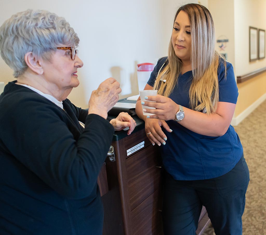 Caregiver engaging with an older adult at a Franklin Park Senior Living community.